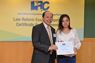 Solicitor General, Mr Frank Poon, awarded a certificate to Miss Bertilla Chow's representative (Miss Janice Ip)